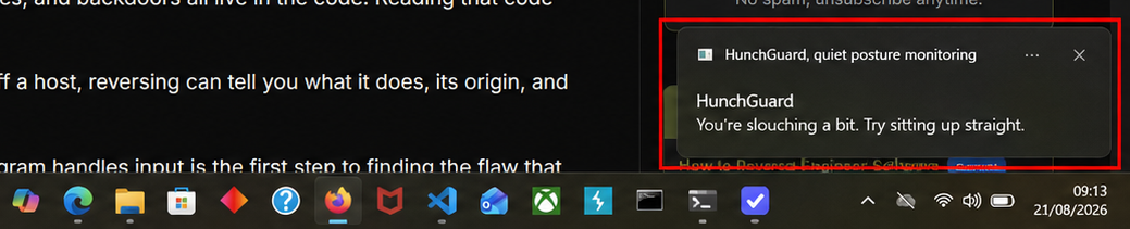 A Windows notification in the corner of the screen reading: HunchGuard, you're slouching a bit, try sitting up straight.